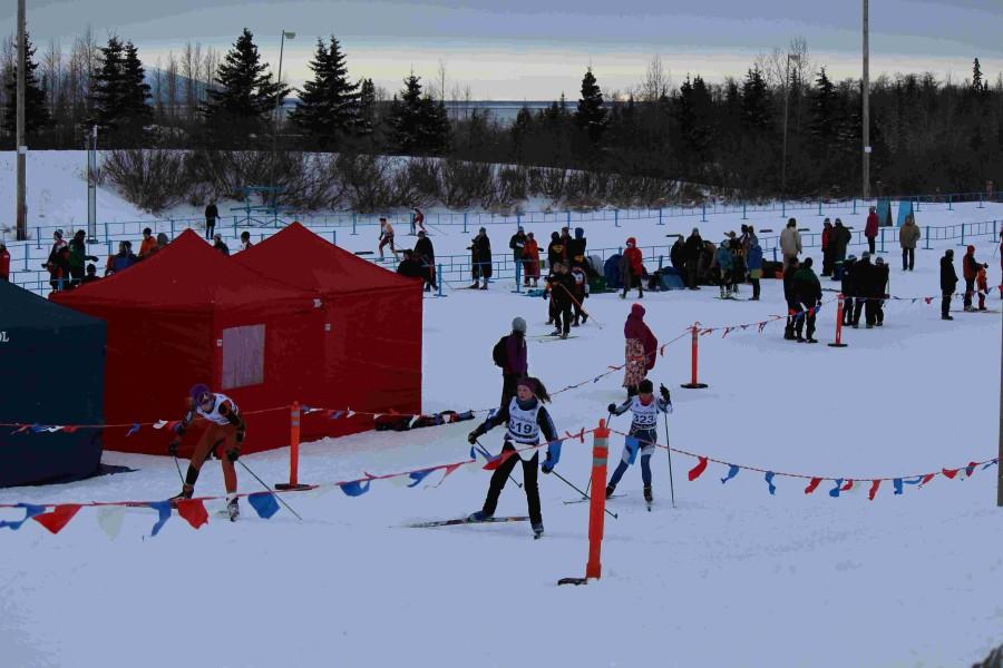 C-Team girls nearing the end of their race (front). Girls open lines up to go (middle). Racers coming in to to the finish (far)