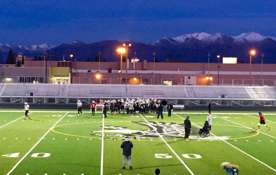 The varsity football team prepares for state, despite the chilly night. 