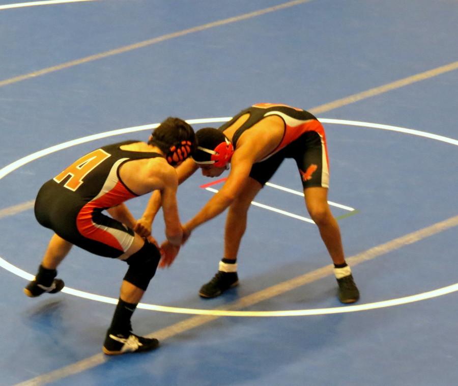 Two West wrestlers grapple in a match.