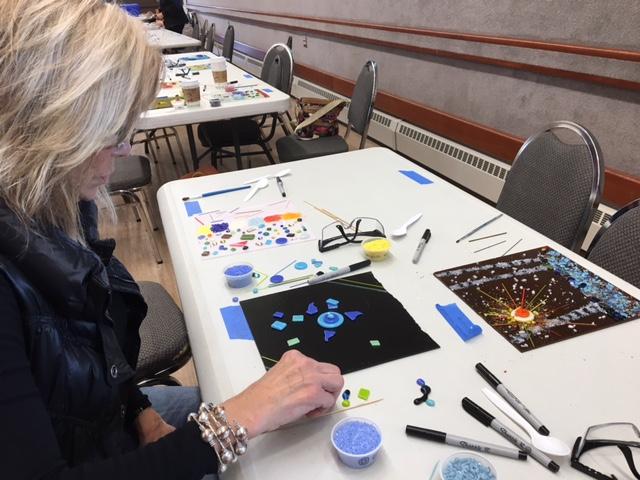 Betty Tuttle works on her glass plate at the Art From The Heart event on Sept. 17 in Palmer, AK.
