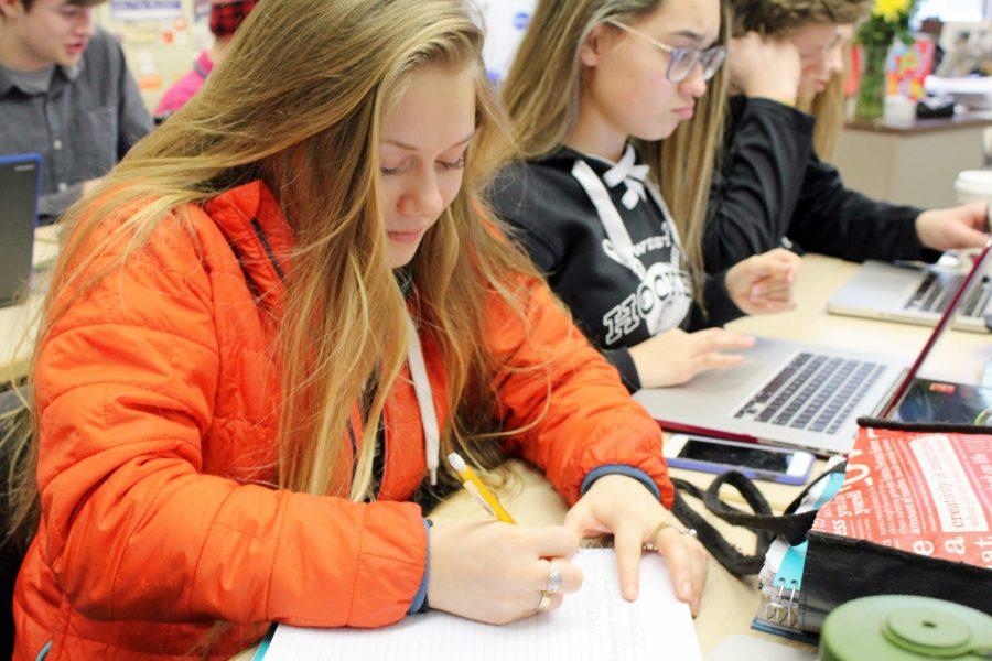 Member of West’s flag football, softball, and hockey cheer teams, Beverly Larson, diligently working during 4th hour with fellow cheerleader, Brianna Williams.
