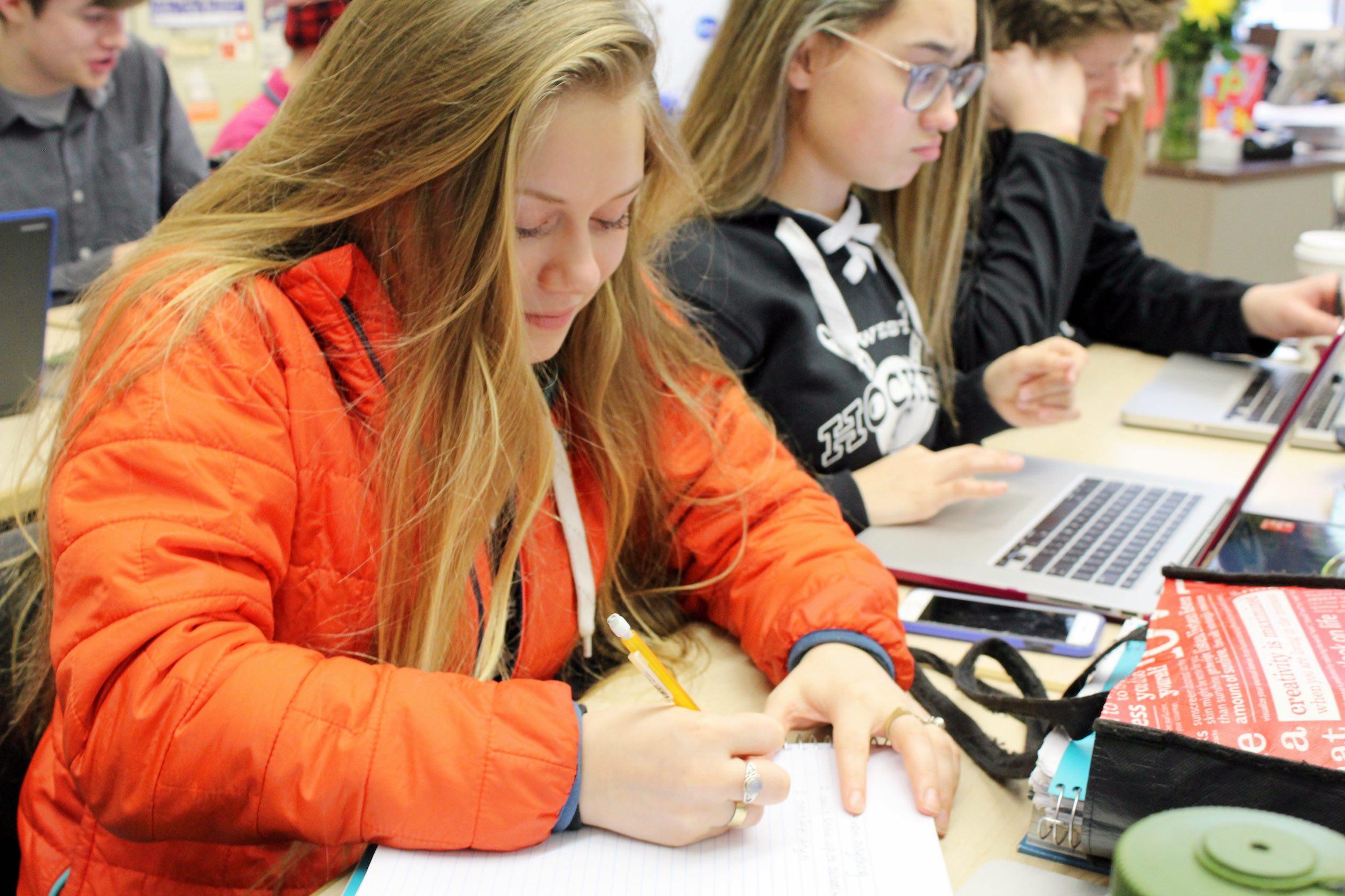 Member of West’s flag football, softball, and hockey cheer teams, Beverly Larson, diligently working during 4th hour with fellow cheerleader, Brianna Williams.