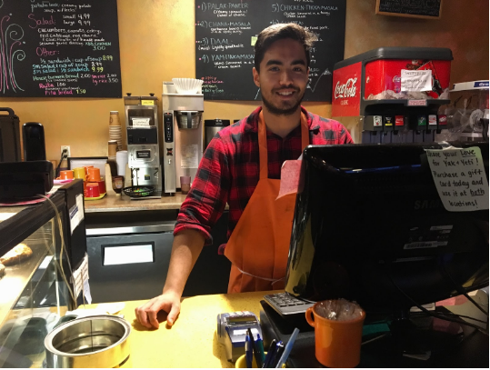 An employee poses as he waits for more customers to come in and order food Yak and Yeti Himalayan Cafe on Nov. 29, 2017.