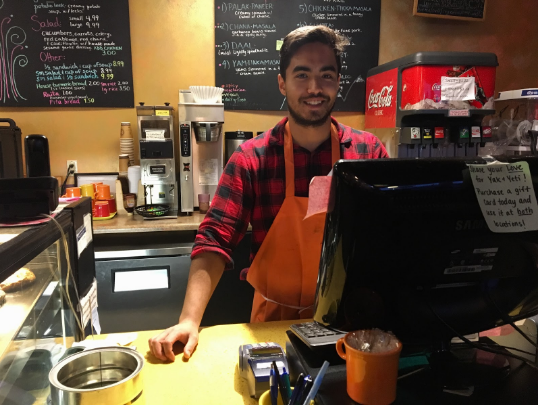 An employee poses as he waits for more customers to come in and order food Yak and Yeti Himalayan Cafe on Nov. 29, 2017. 