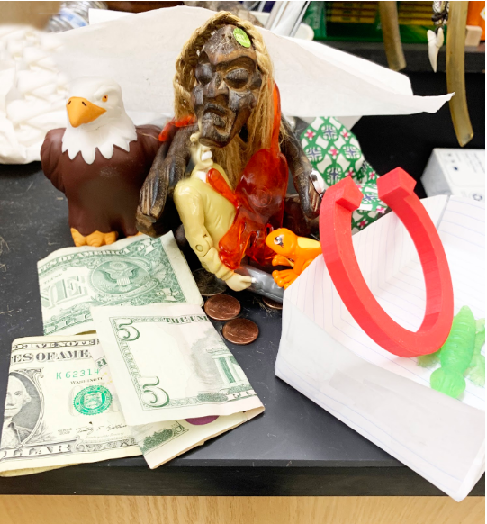 "Geoffrey" regally poses with his numerous offerings as the West High eagle looks on.