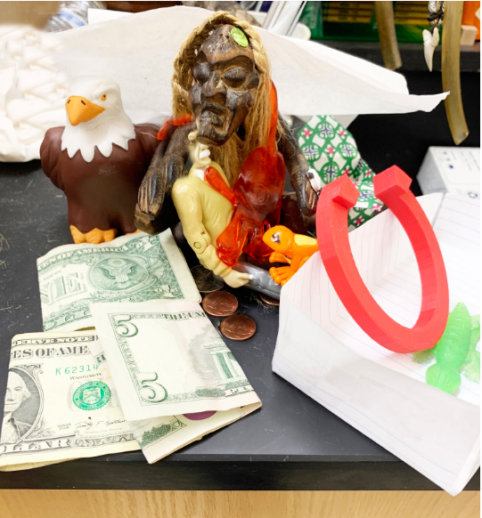 Geoffrey regally poses with his numerous offerings as the West High eagle looks on.