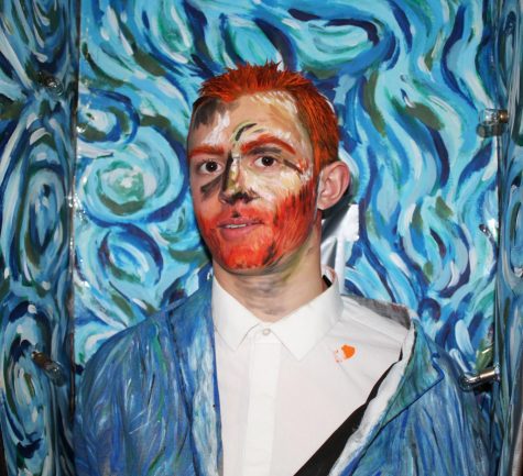 Noah Goltz, a junior in the IB Art class, poses to show off his painting after the show.  He chose to recreate “Self-Portrait” by Vincent Van Gogh. 
