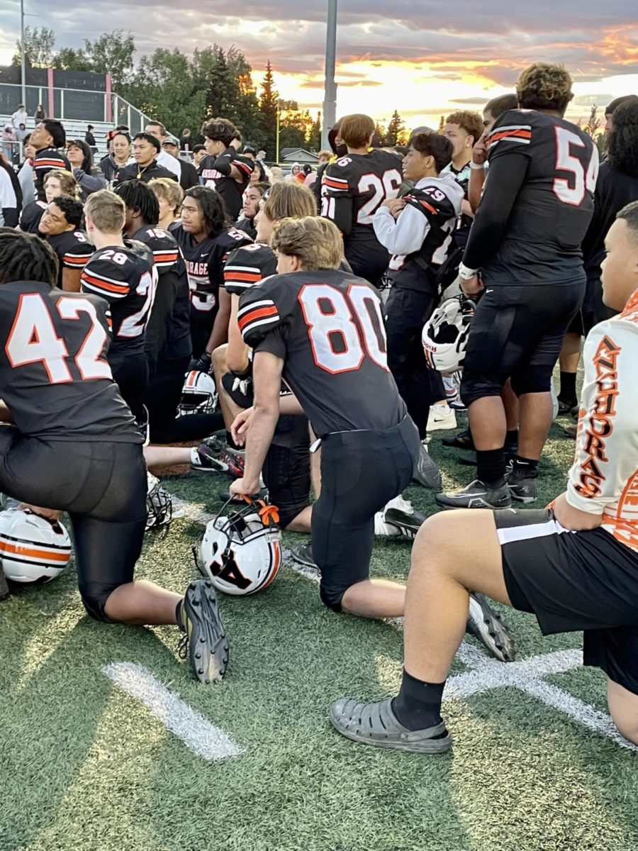 The varsity football team takes a knee after the game on August 11th. 